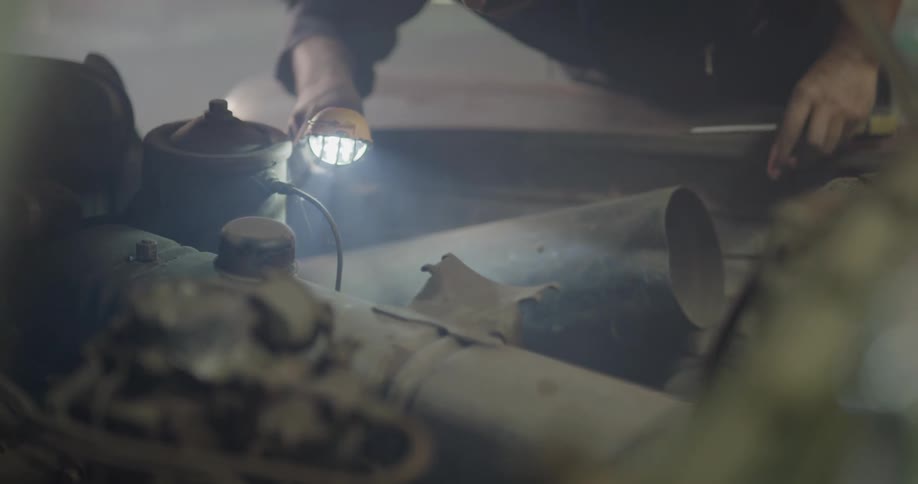 A man works on the vehicle
