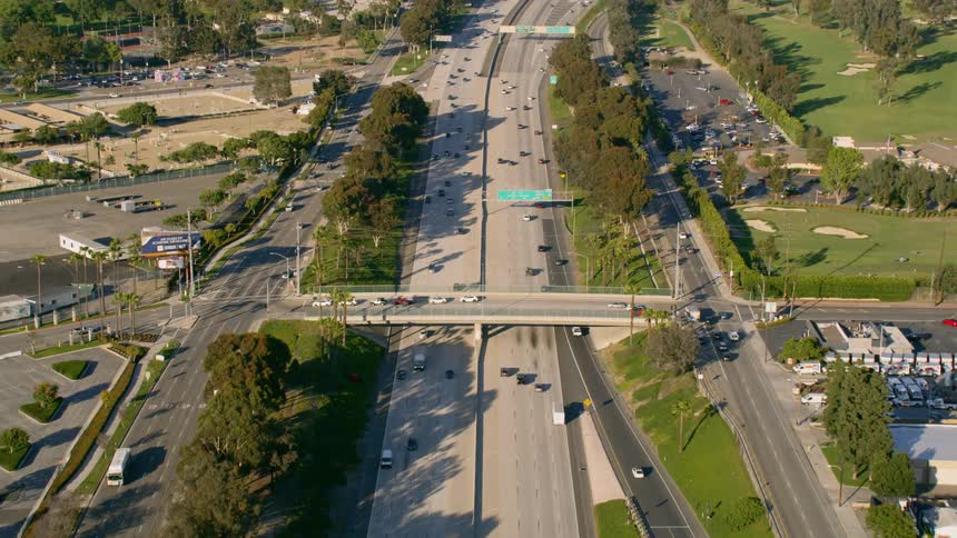 Slow motion aerial of commuters on a freeway on their daily commute