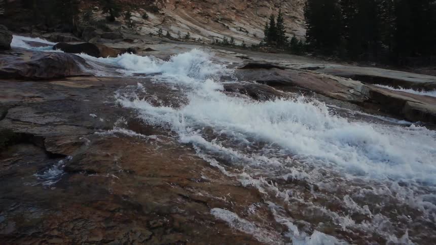 Water rushes down a rocky stream