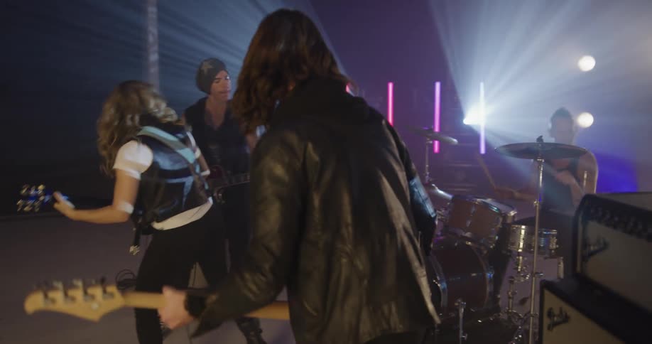 A band playing aggressively in a room