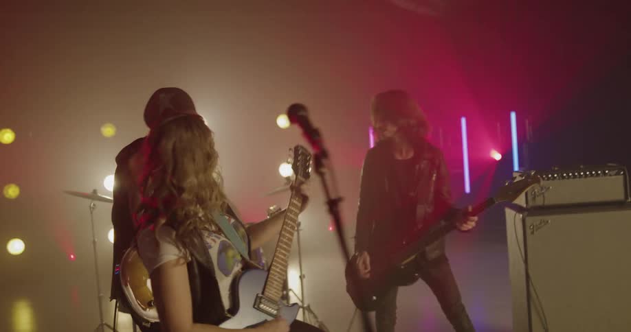 A band with four musicians performs on stage