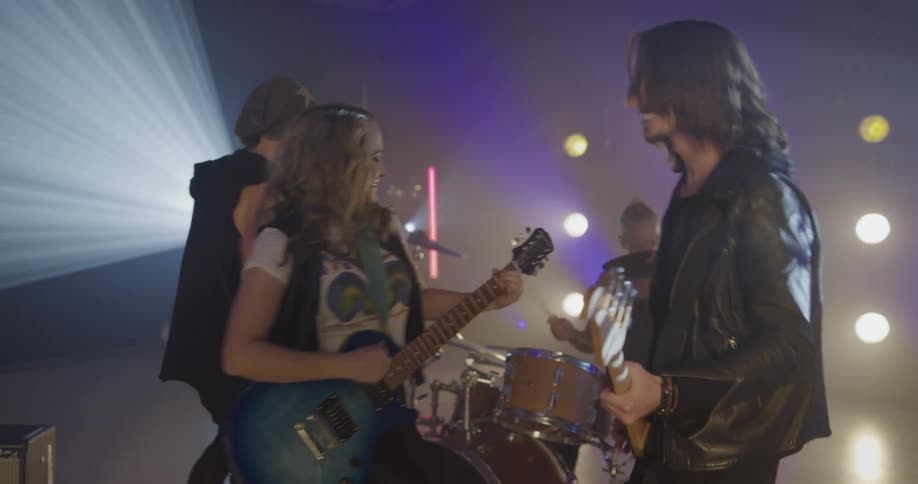 Rock band performs on stage with light show