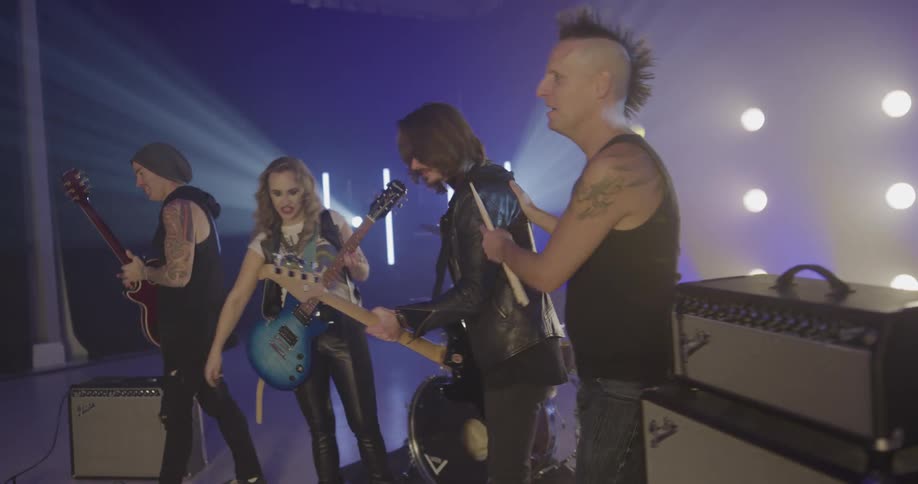 A group of band members fist bump each other after a performance