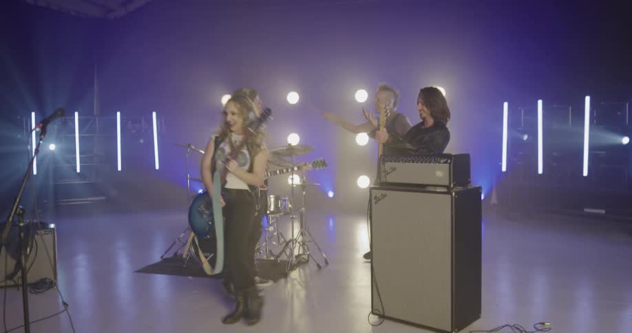 Male and female band members gather together with their instruments