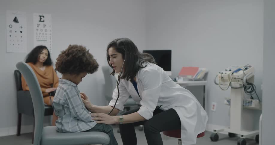 The doctor checks the boy