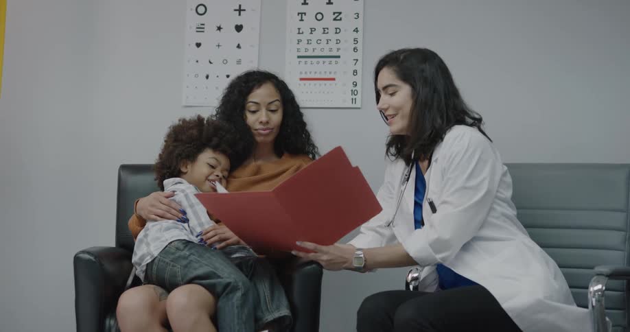 A doctor shows paperwork to the patient