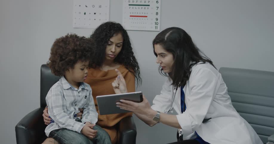 A doctor talking to a mother and son