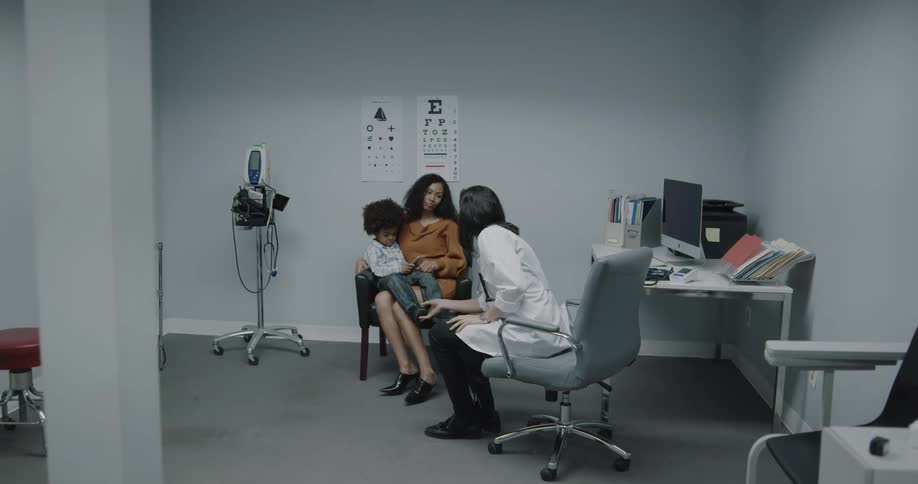 Doctor enters room to greet mother and her child