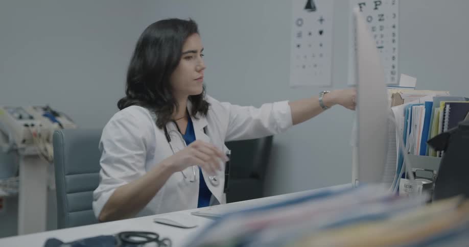 A receptionist types at a medical office