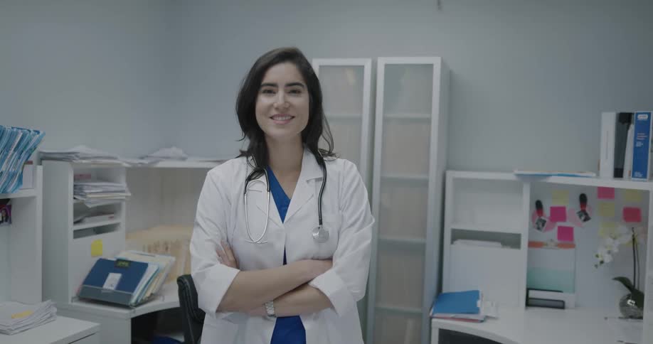 A nurse puts a stethoscope around her neck and turns and smiles