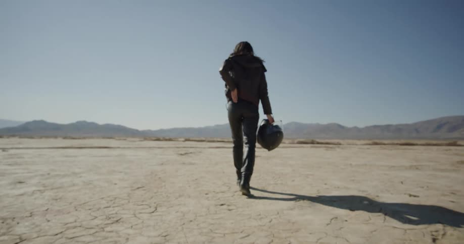 A woman walks in the desert