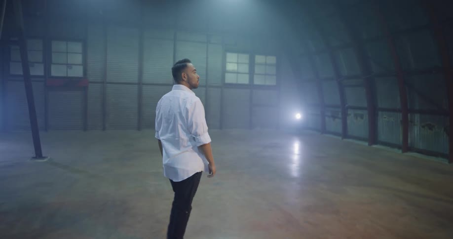 A man walks in to an empty room and looks around
