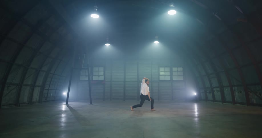 A man dances inside a building