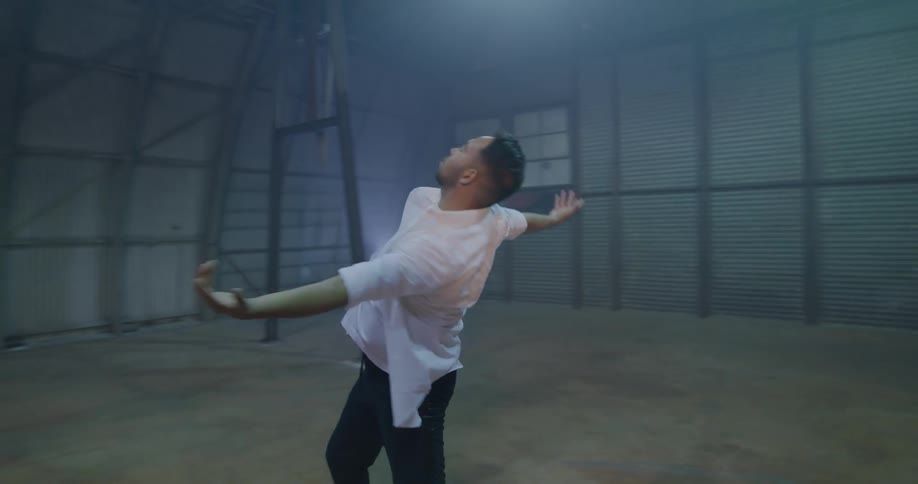 A man dances in an open room