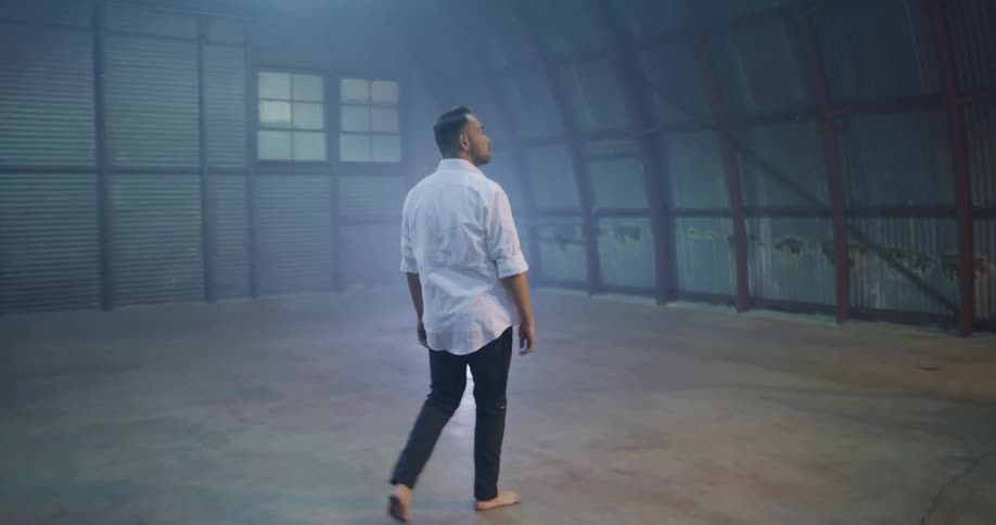 Man walks into empty building and looks it over