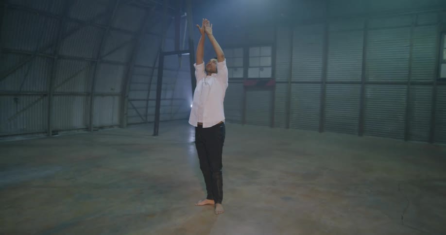 Barefoot male dancer dances indoors