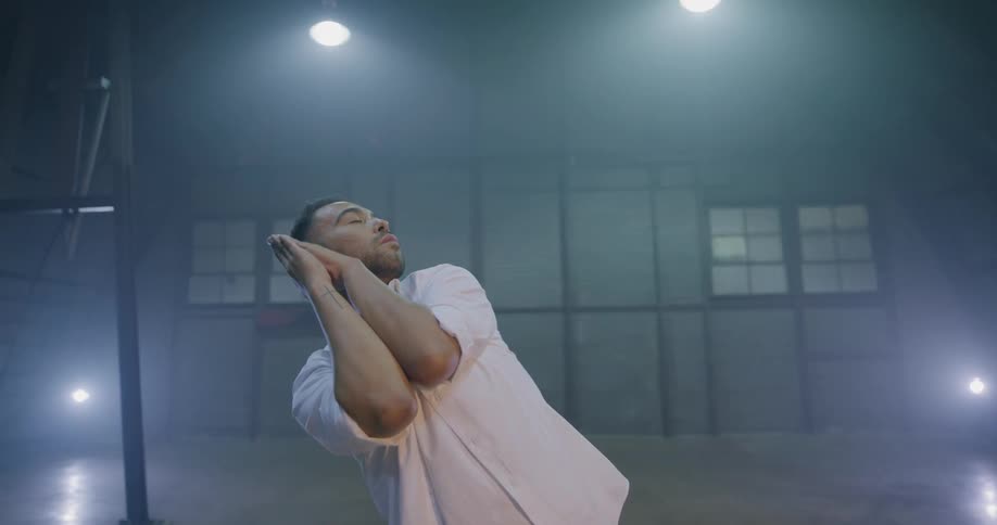 A man dances in a large room