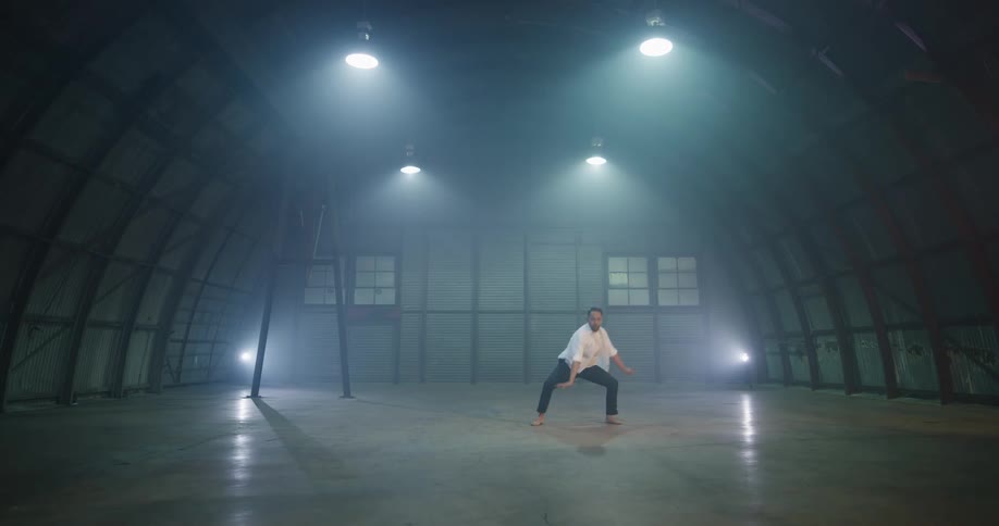 The man dances in the building