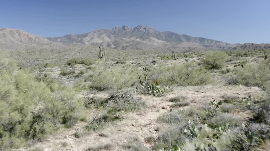 Wide open desert plains lead to a canyon
