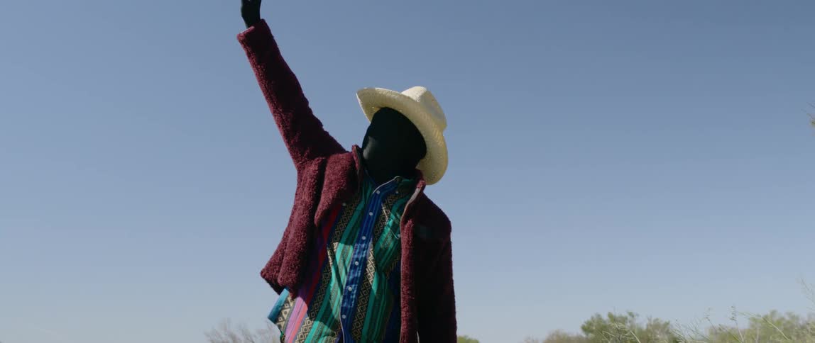 The man reaches toward the sun