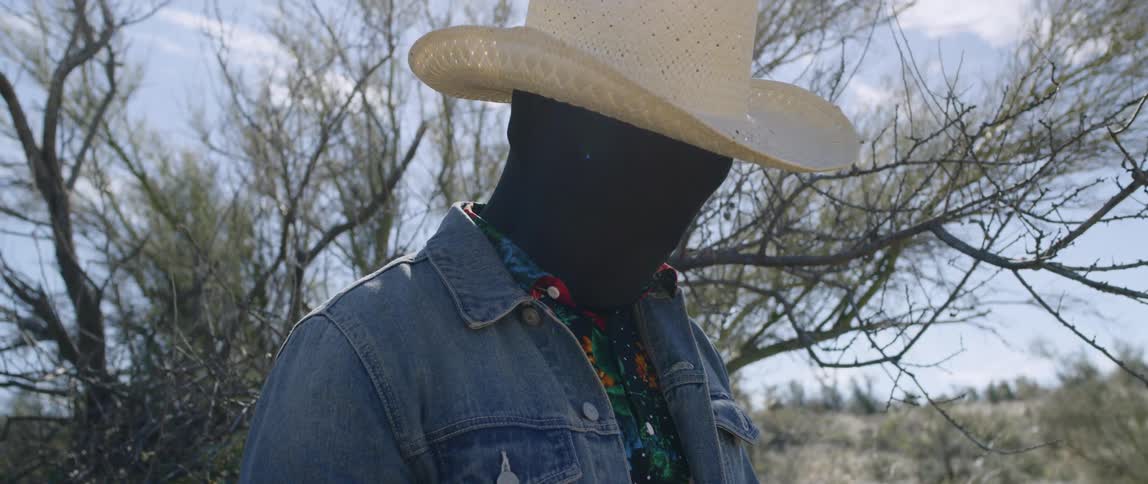 A person in a morph suit standing in a field