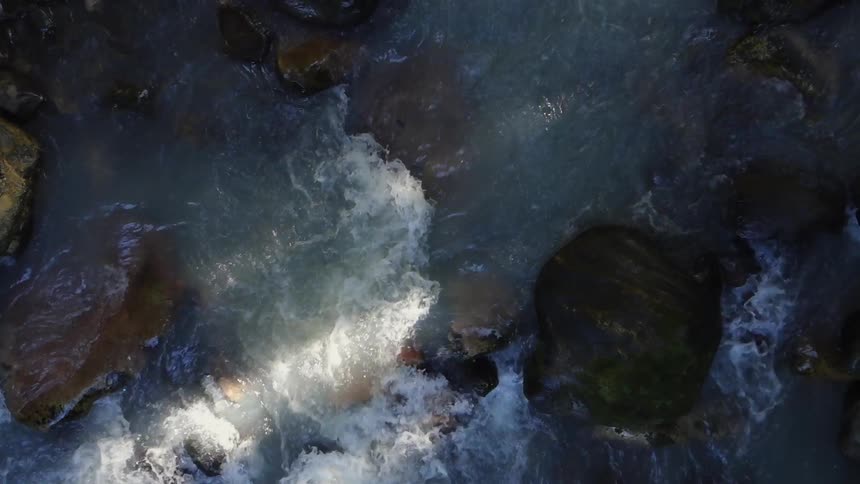 Water flows over rocks in a stream