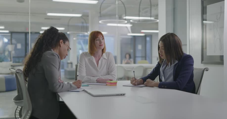 A group of women talking around a table