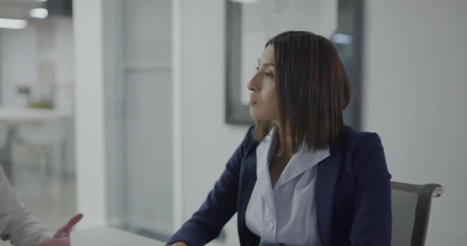 Women sitting in an office talking in a meeting