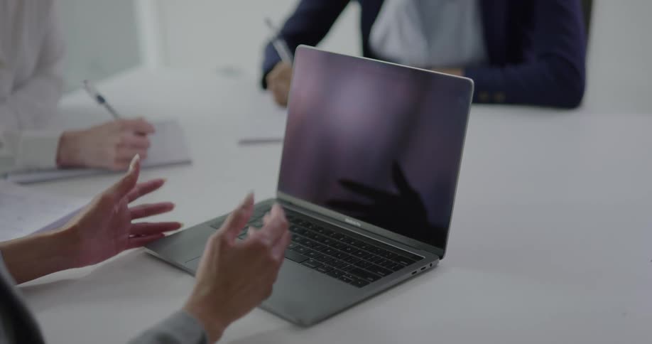 A person trying to use a laptop that is not turned on