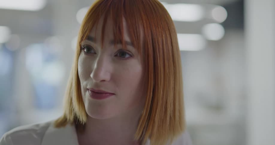 A woman in an office talks with people