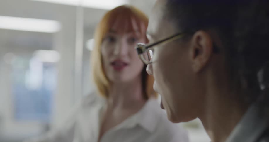 Two women brainstorm in an office