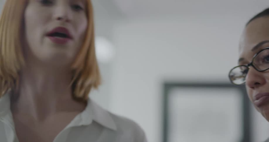Two women discuss details