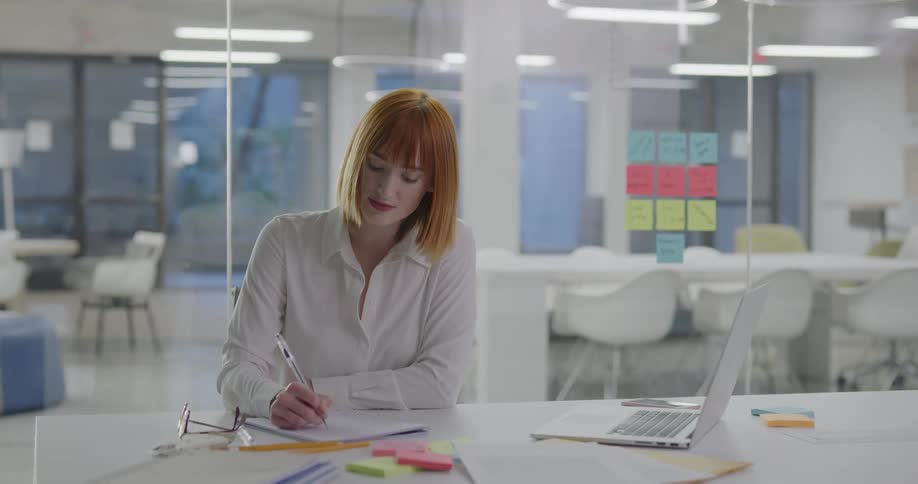 A woman works at her desk
