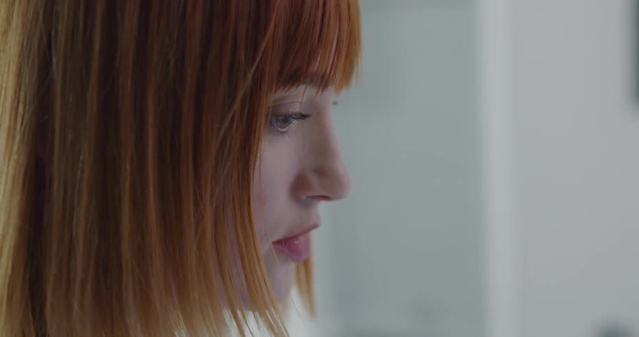 A womans face in an office as she works