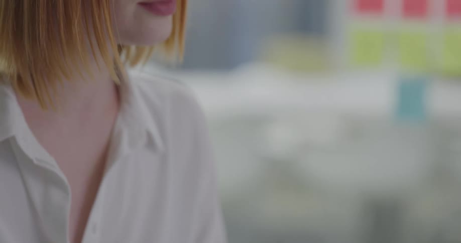 A woman types on a laptop in an office