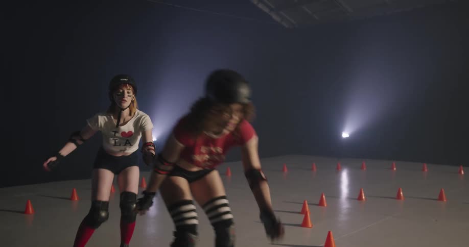 Women racing on roller skates indoors