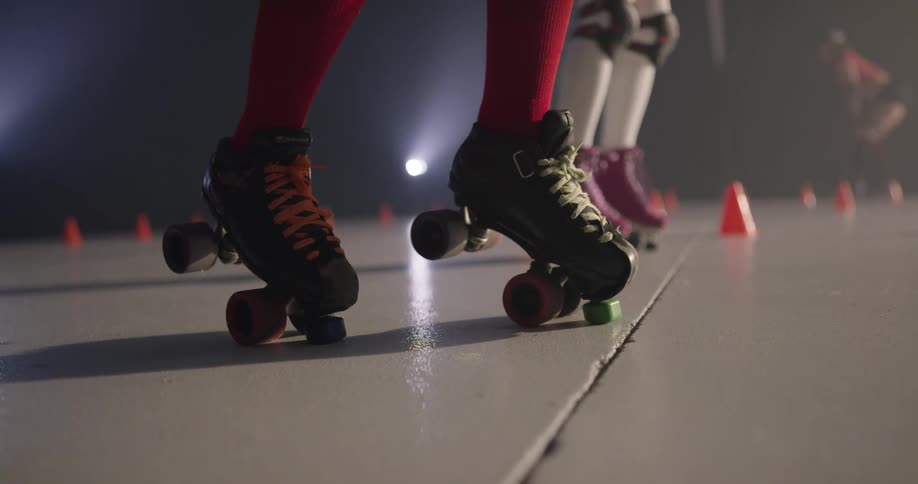 Women move along the ground using roller skates in the roller skating rink