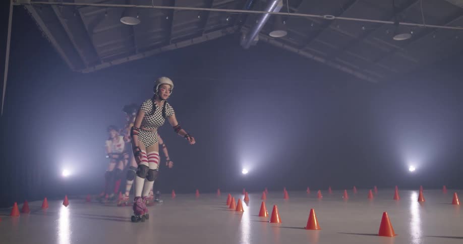 Women compete in roller skate race indoors