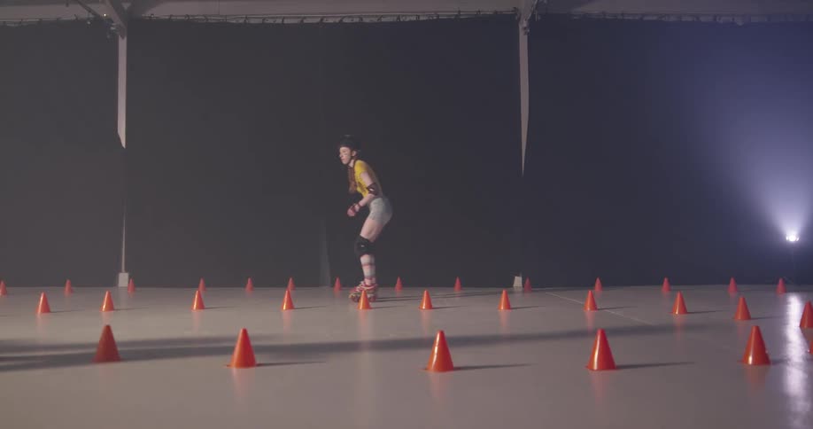 Many women skate around the cones