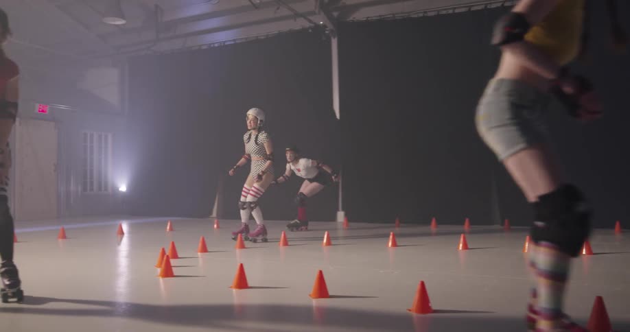 Four women race one another on roller skates