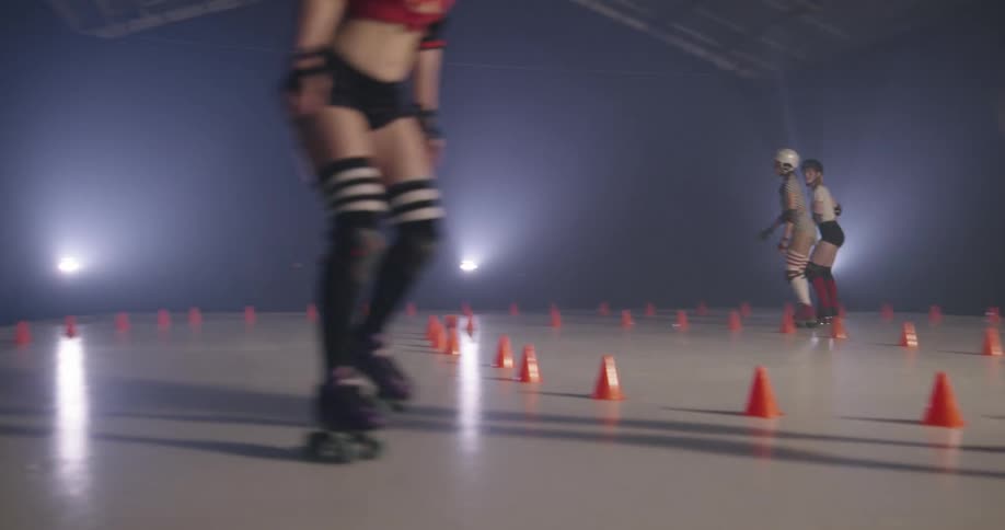 Four women roller skate in a circle