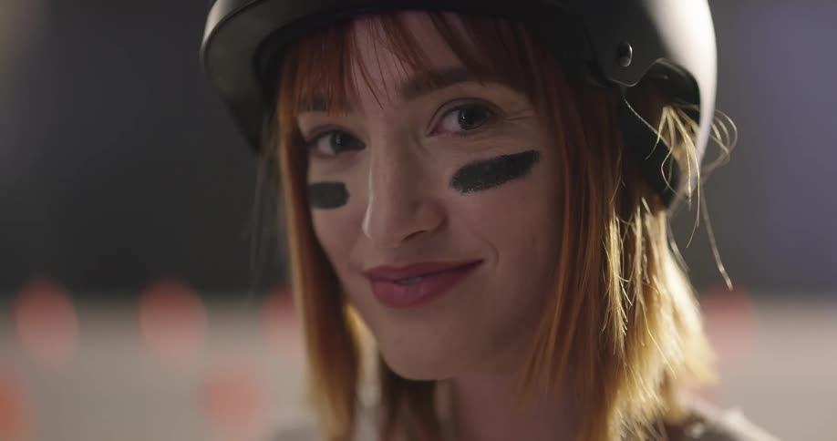 A woman wearing a helmet smiles for a picture