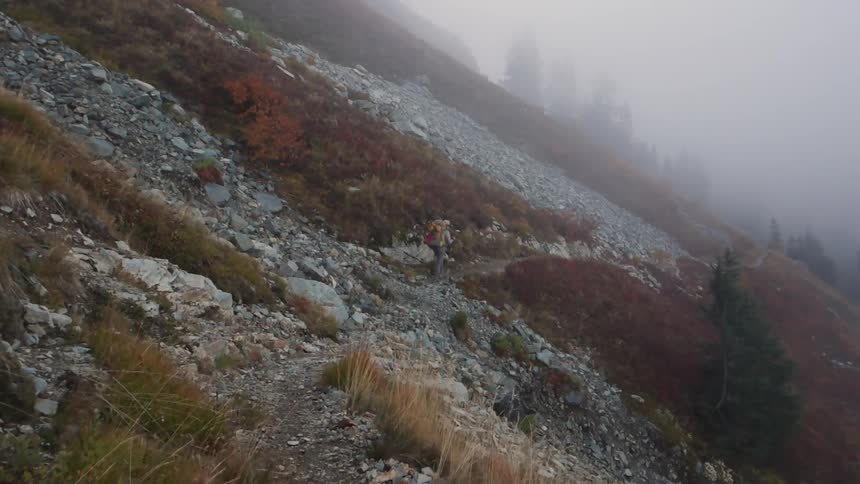 A person walking over a large rocky field