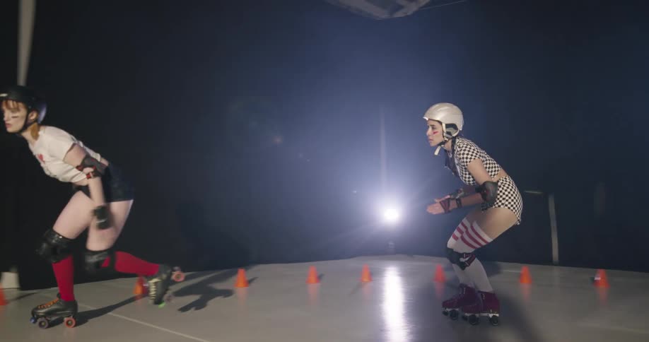 Three women race each other on roller skates