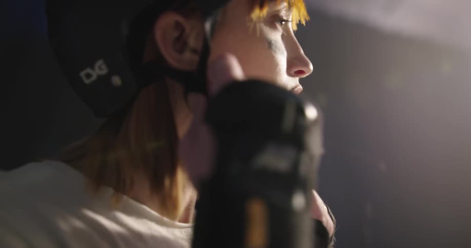 A woman adjusts her helmet