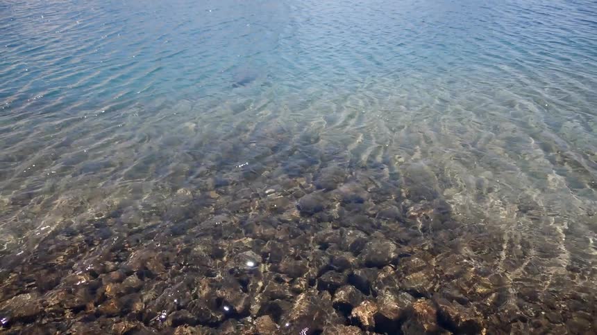 Water rippling over rocks along a shoreline