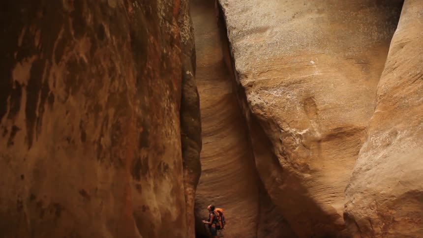 Someone is hiking inside of a canyon