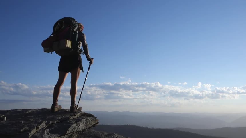 Someone looking over the edge of a mountain cliff