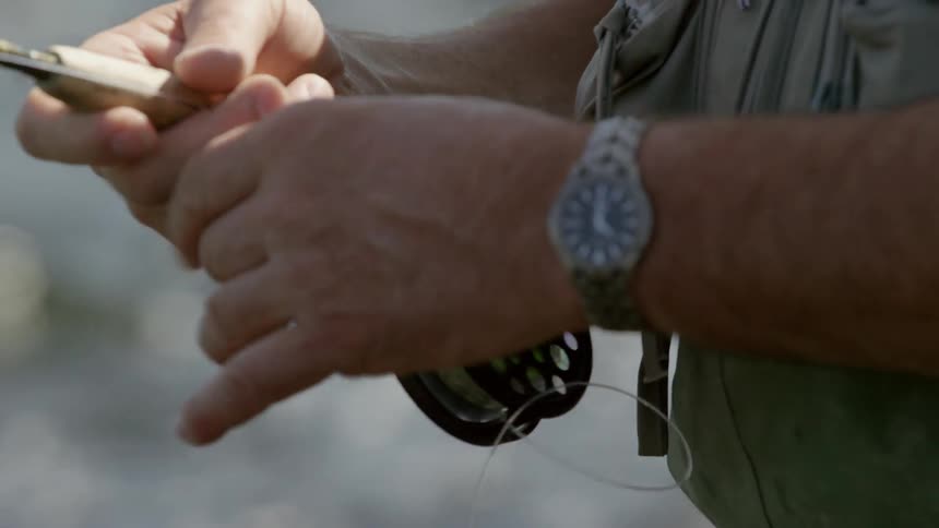 Close up view of a guy fishing in a lake