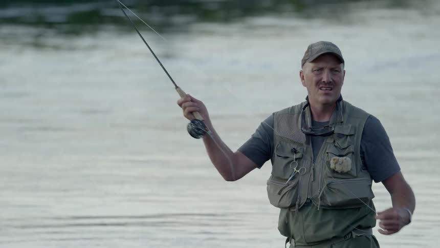 A man is fly fishing in a river